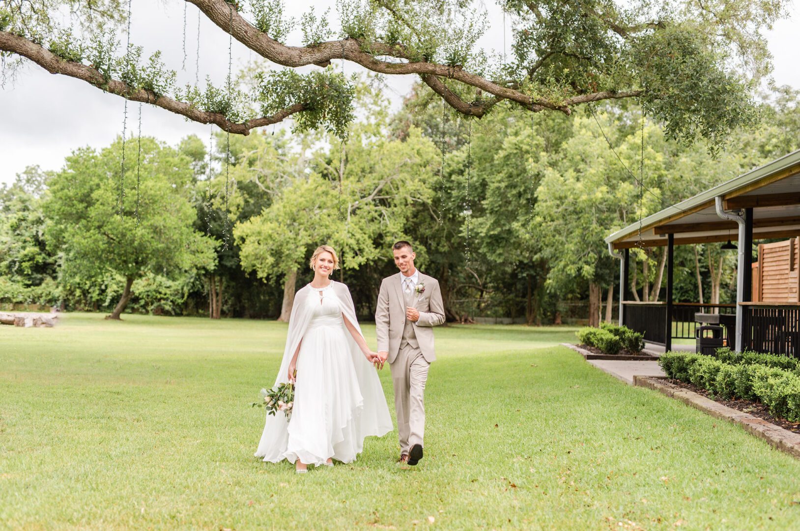 A man and woman walking across the grass.