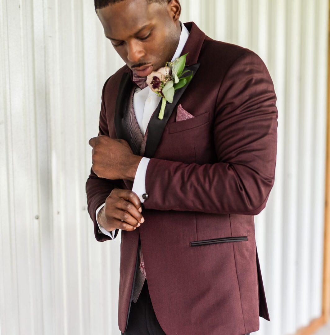 A man in a suit and tie looking down.