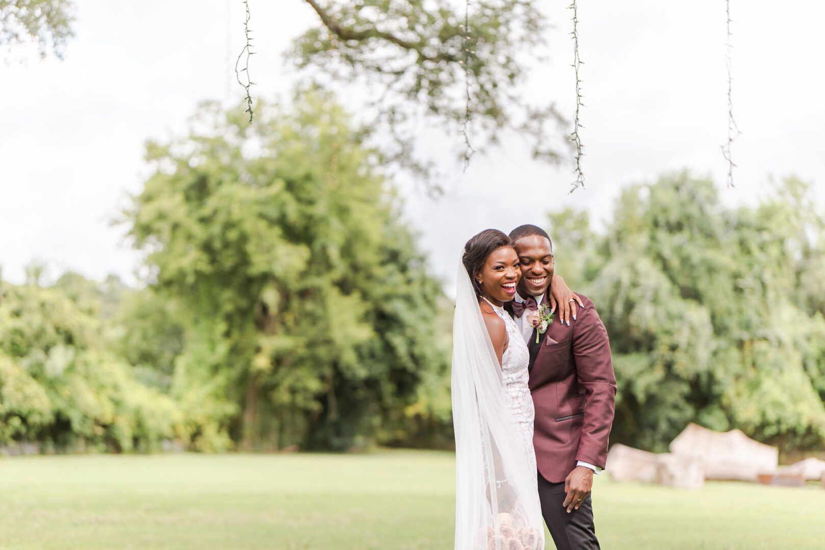 A couple posing for a picture on the swing.