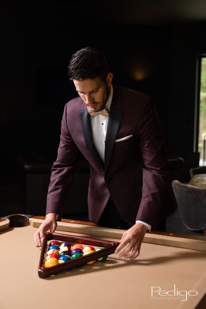 A man in a suit and tie holding onto some balls