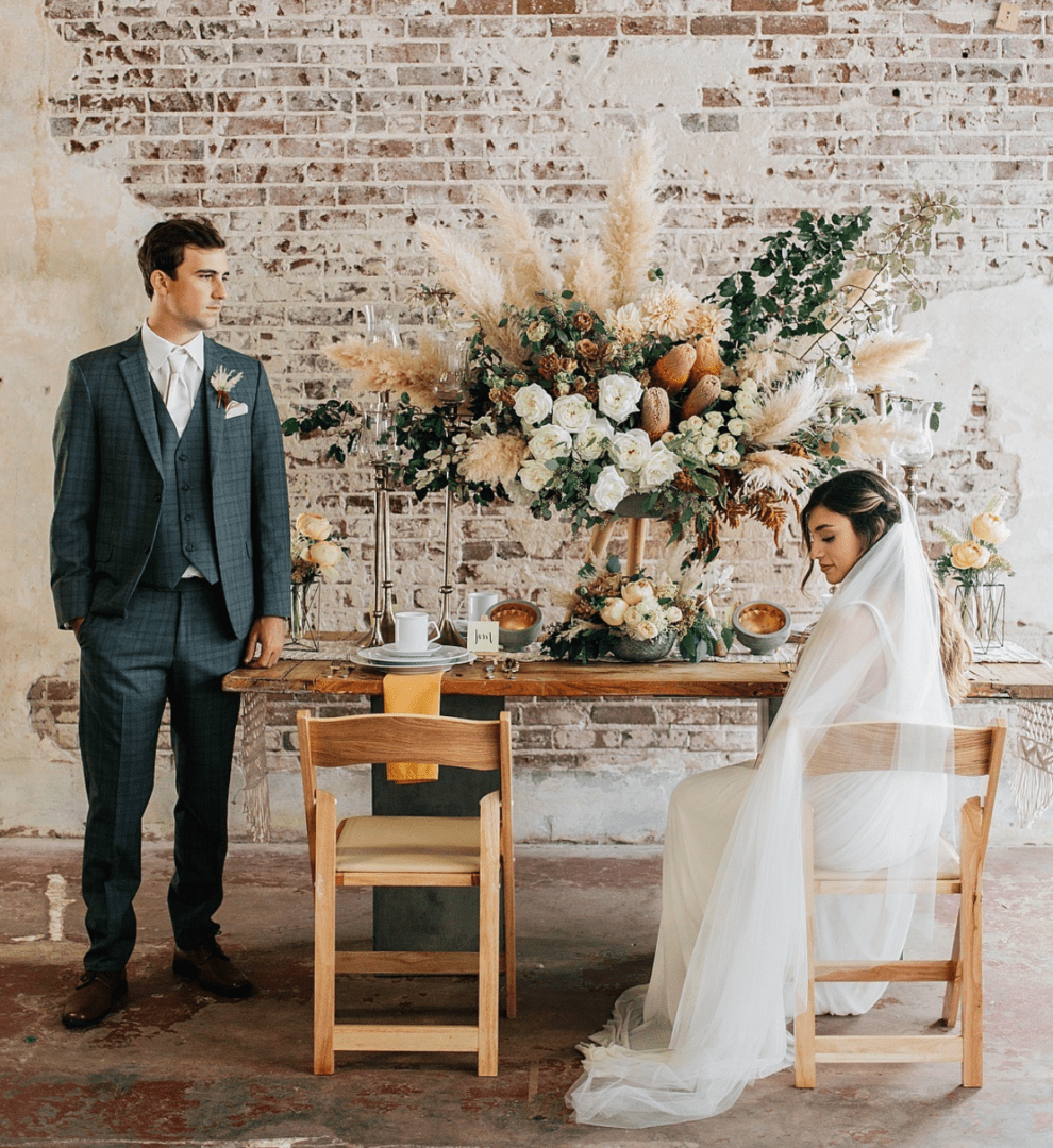 A man and woman standing at the table