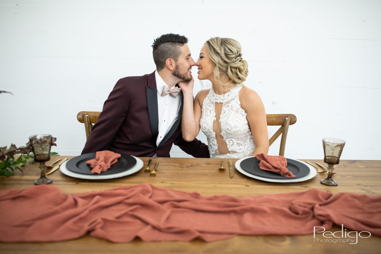 A man and woman kissing at the table