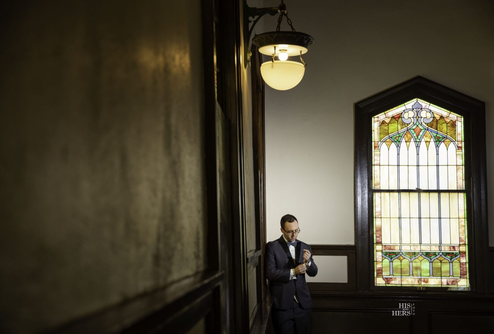 A man standing in front of a window.