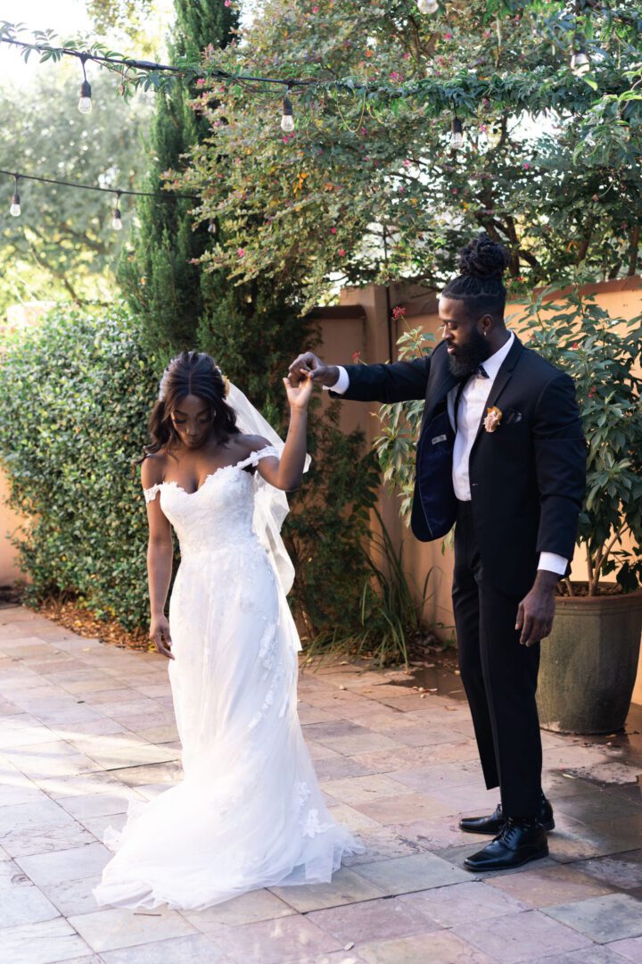 A man and woman holding hands while walking.