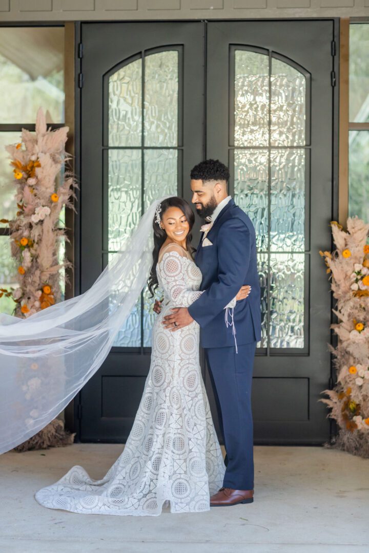 A bride and groom pose for a picture.