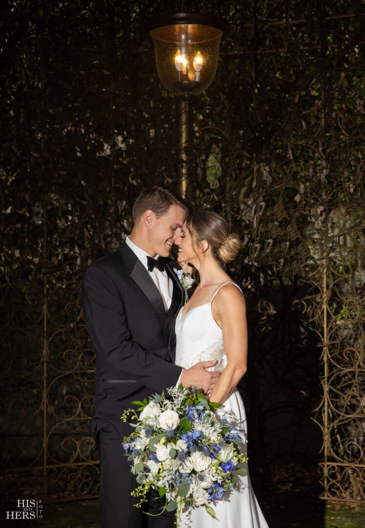 A man and woman in formal wear holding each other.