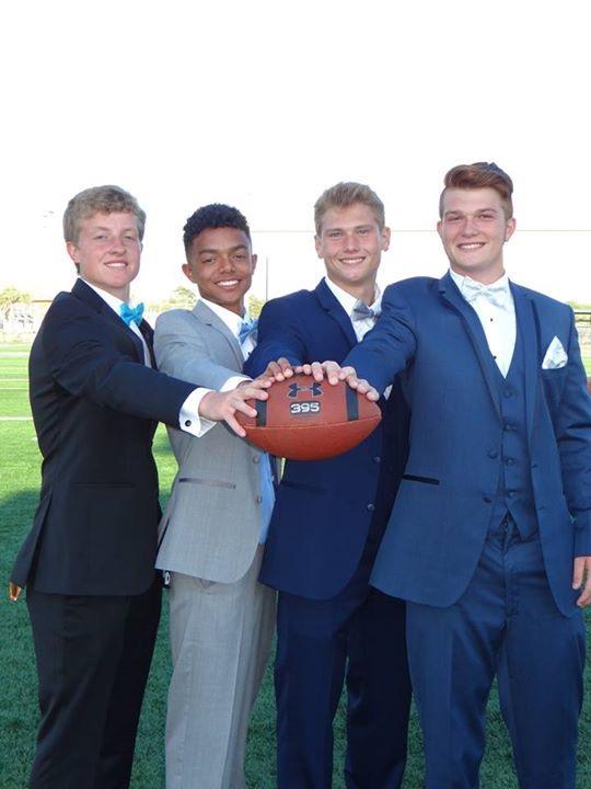 A group of young men holding onto a football.