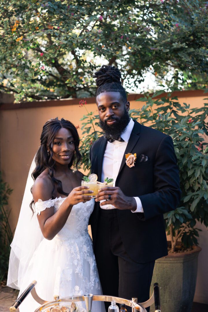 A man and woman holding drinks in their hands.