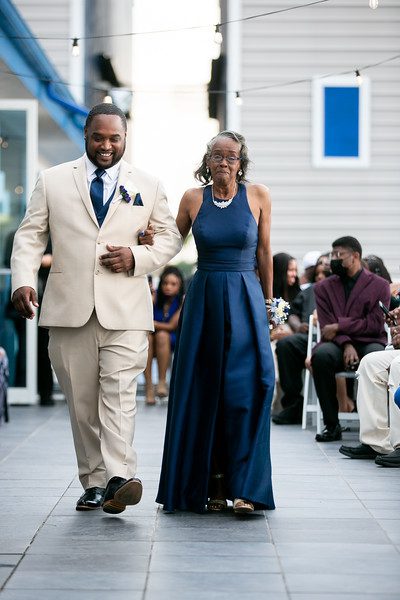 A man and woman walking down the aisle.