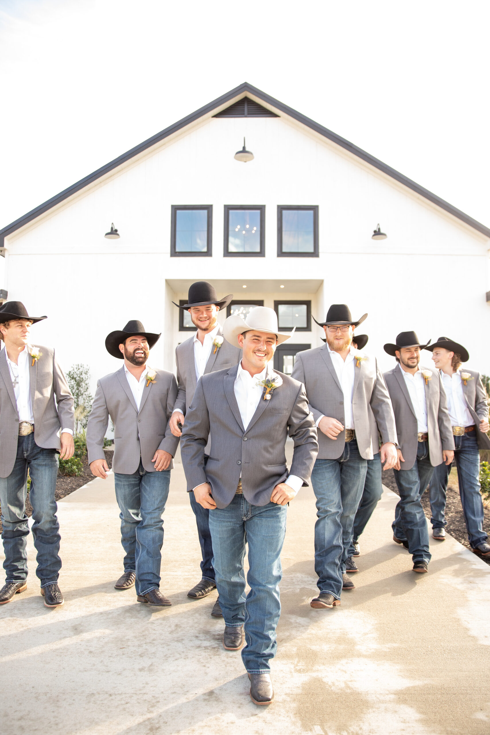 A group of men in cowboy hats and jeans.